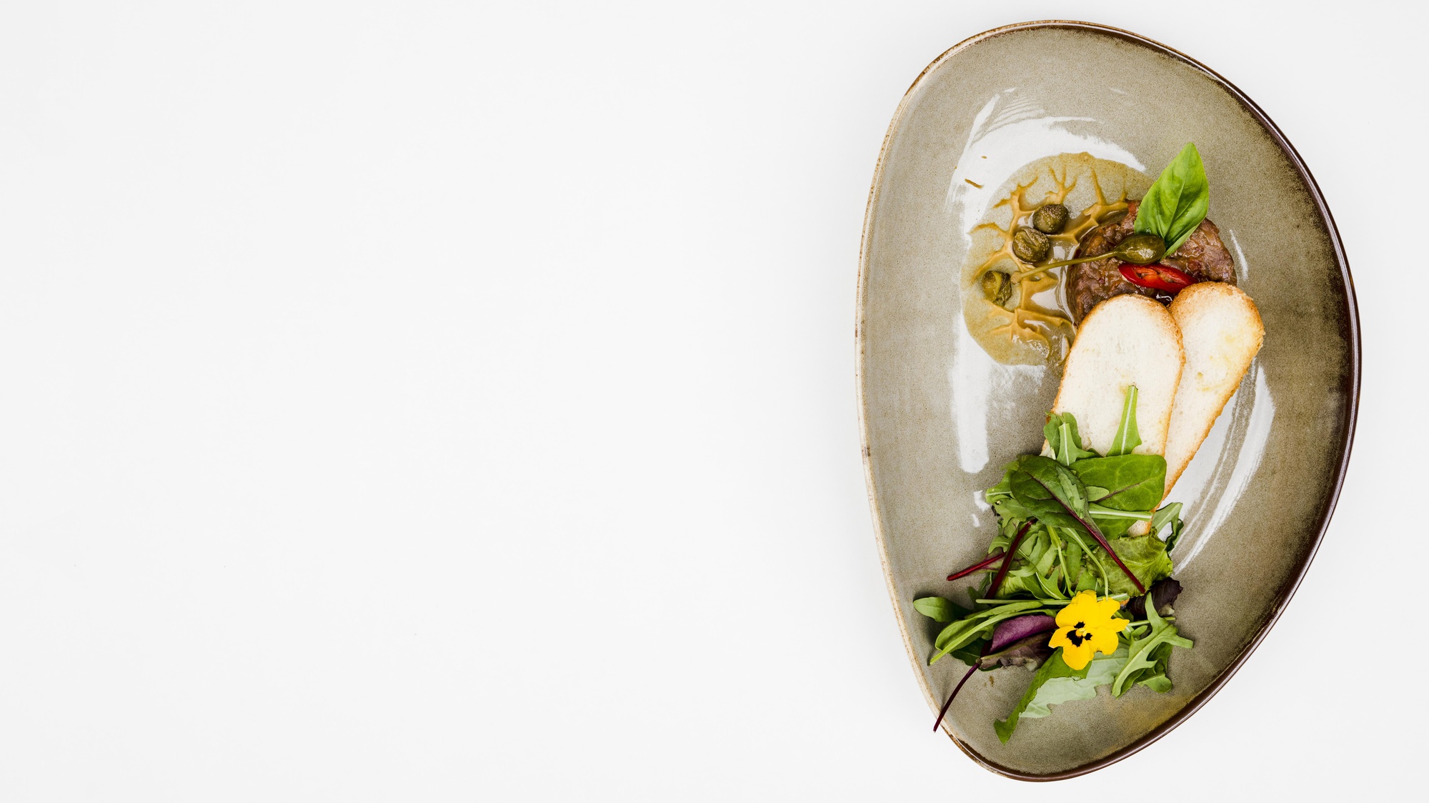 Plated dish styled editorially on a paper-like card